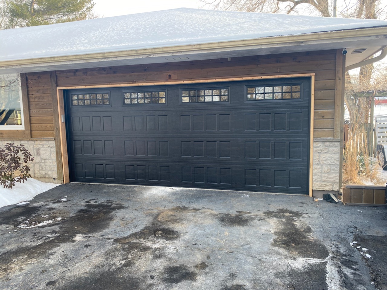 Black carriage style garage door installation in Kansas City