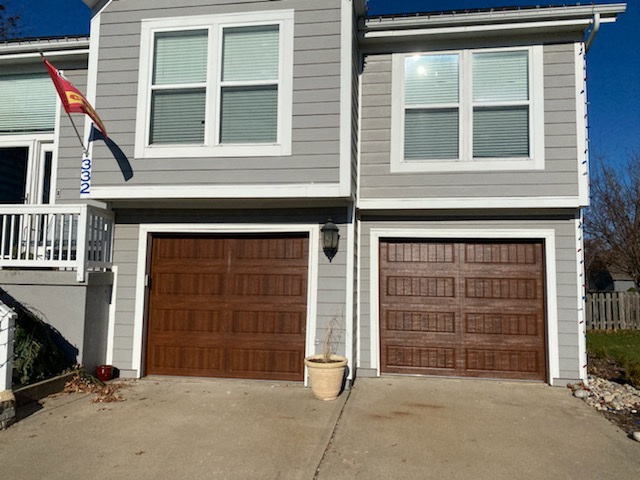 Oak finish carriage doors installed in Lee's Summit, MO
