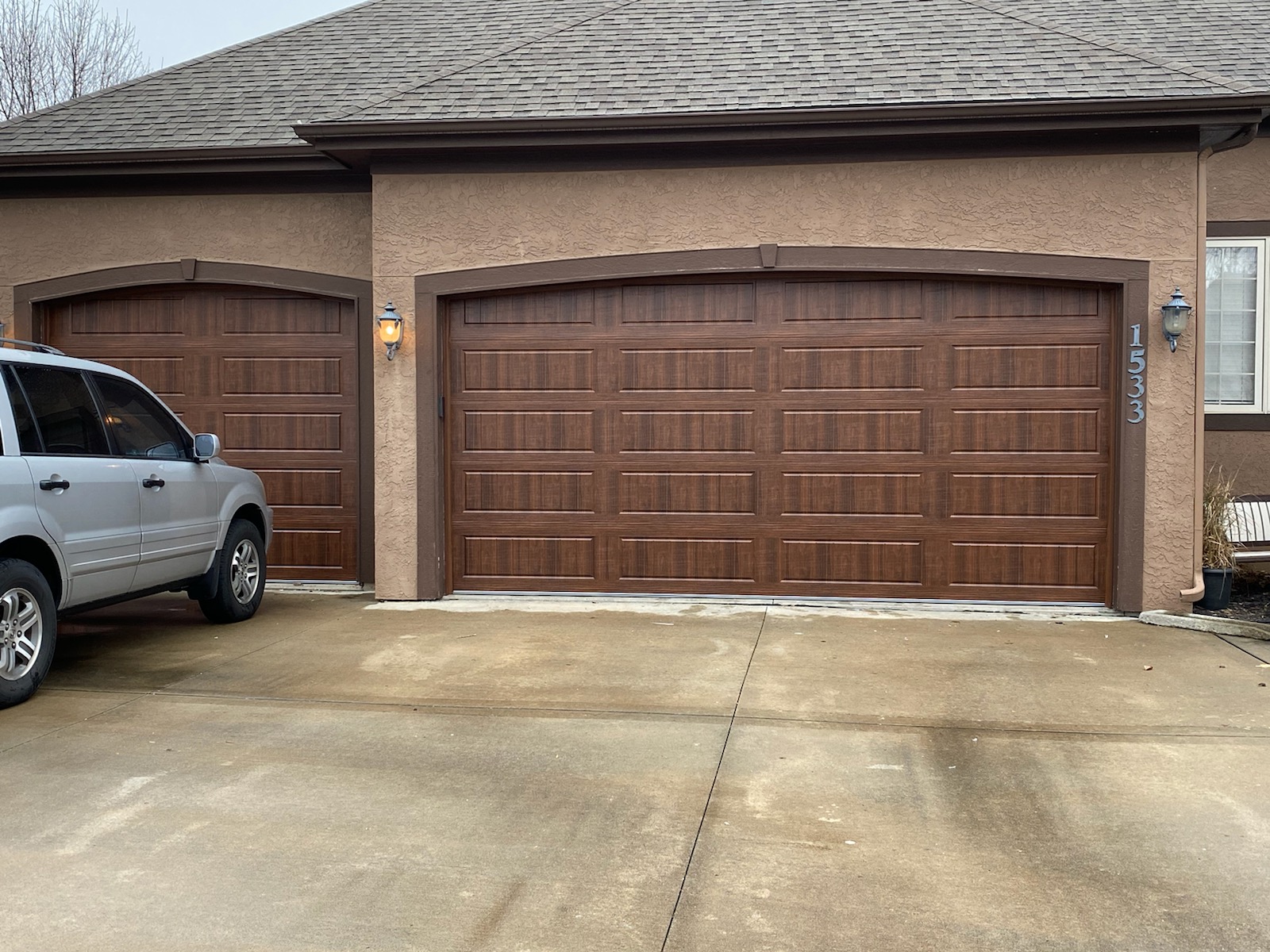 Dark walnut finish garage doors in Grain Valley, MO